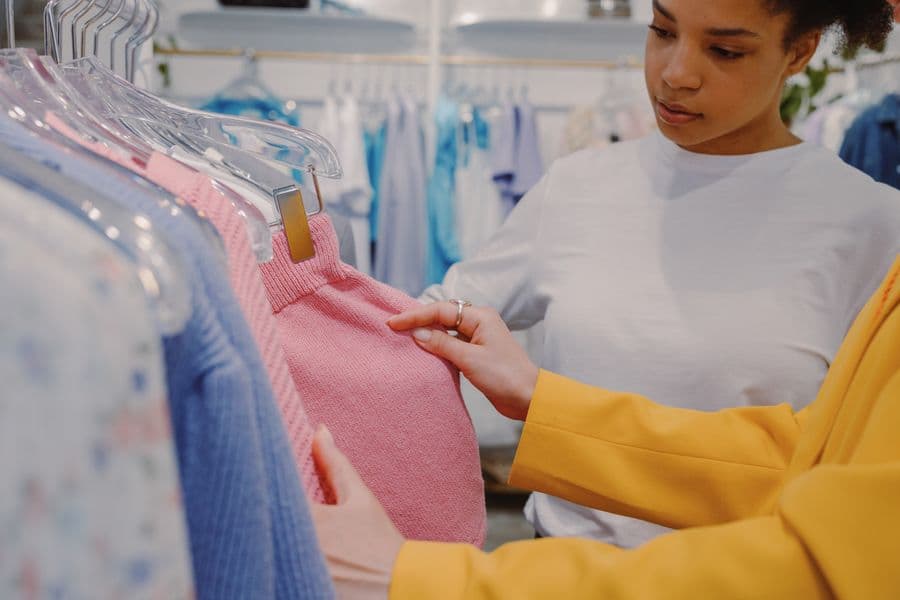Two people choosing clothing together in a boutique